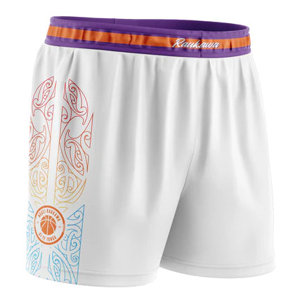 white basketball shorts featuring a traditional Maori design and the Raukawa Basketball logo and a purple and orange trim around the waist