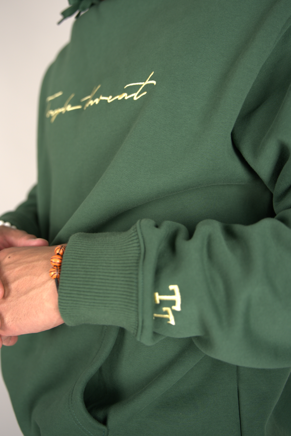 Close-up of Green Script Hoodie on model