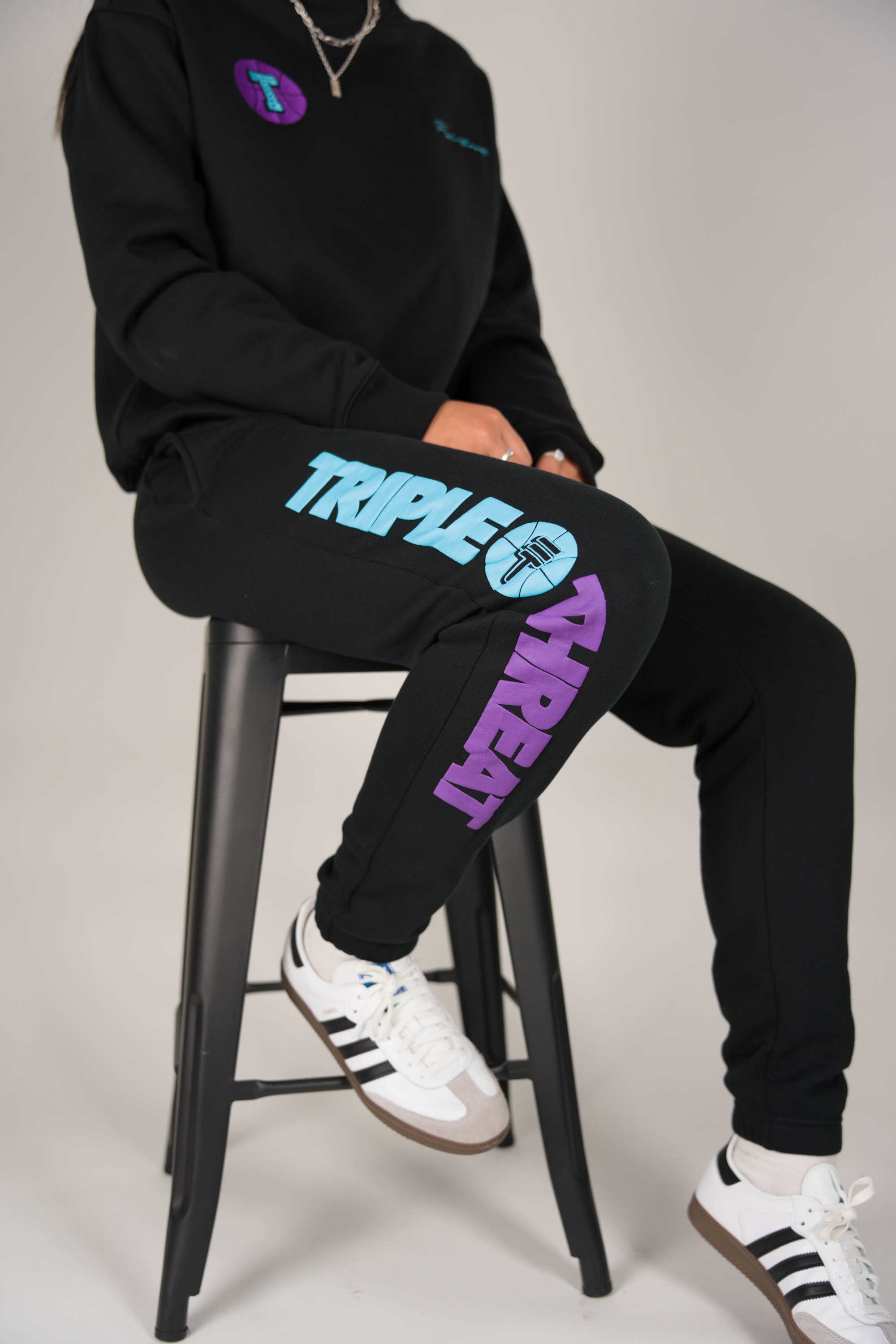 Female model wearing Triple Threat track pants