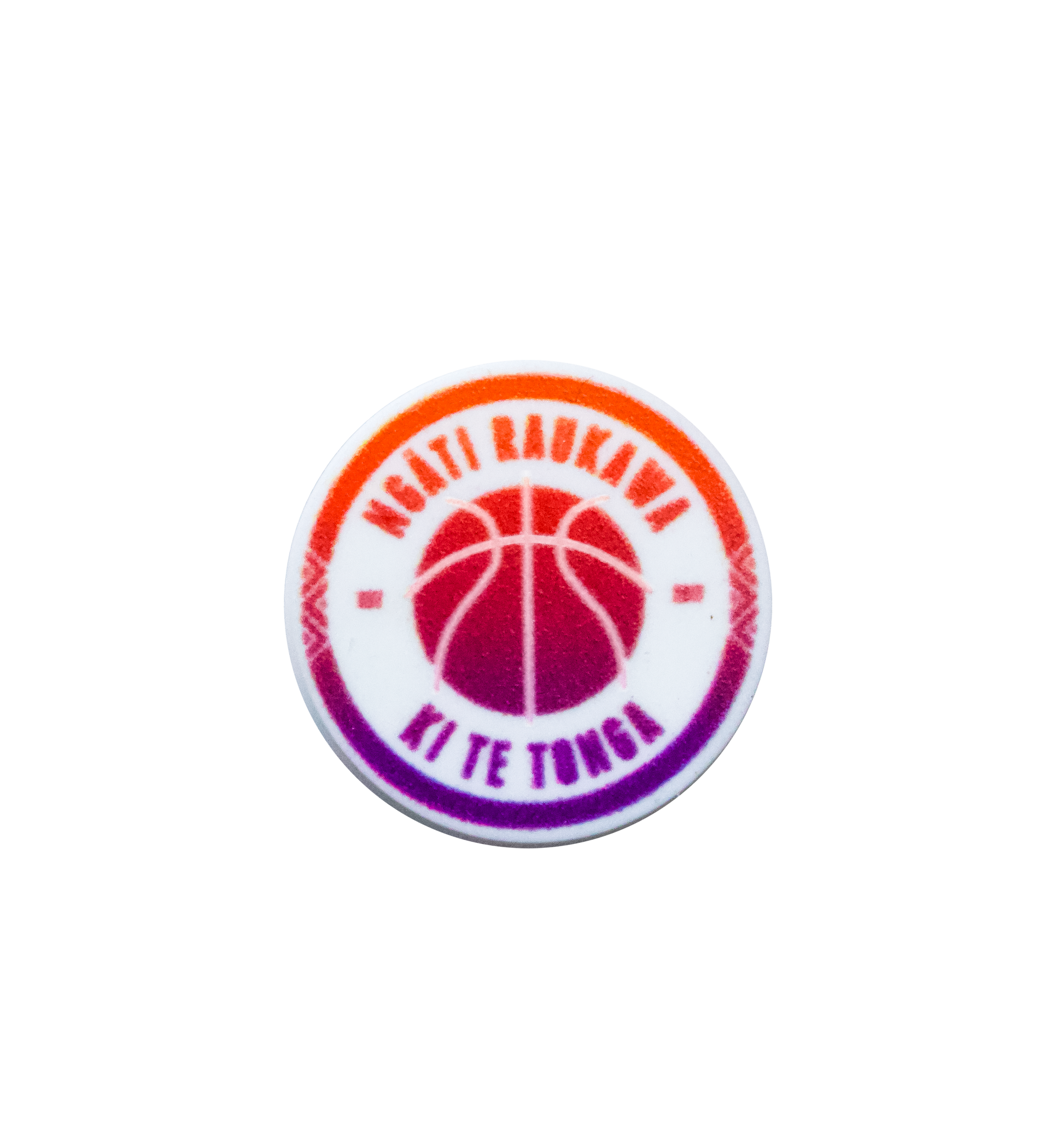A circular basketball-themed Jibbitz charm with a gradient colour scheme from orange to purple. It features the text "NGATI RAUKAWA" at the top and "KI TE TONGA" at the bottom, encircling a basketball graphic in the centre