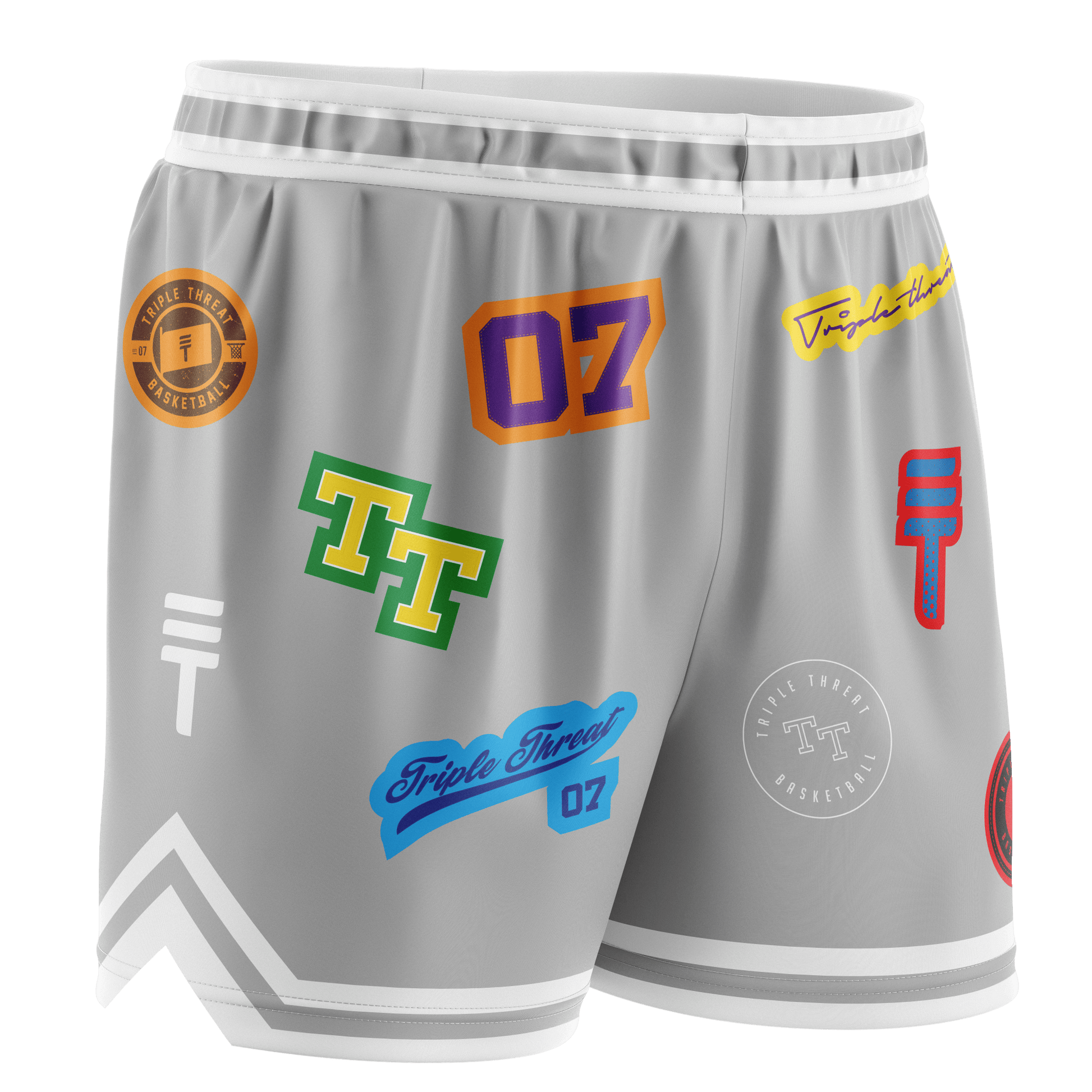Grey basketball shorts featuring various colourful logos and designs, with an elastic waistband, white trim, and the Triple Threat logo.