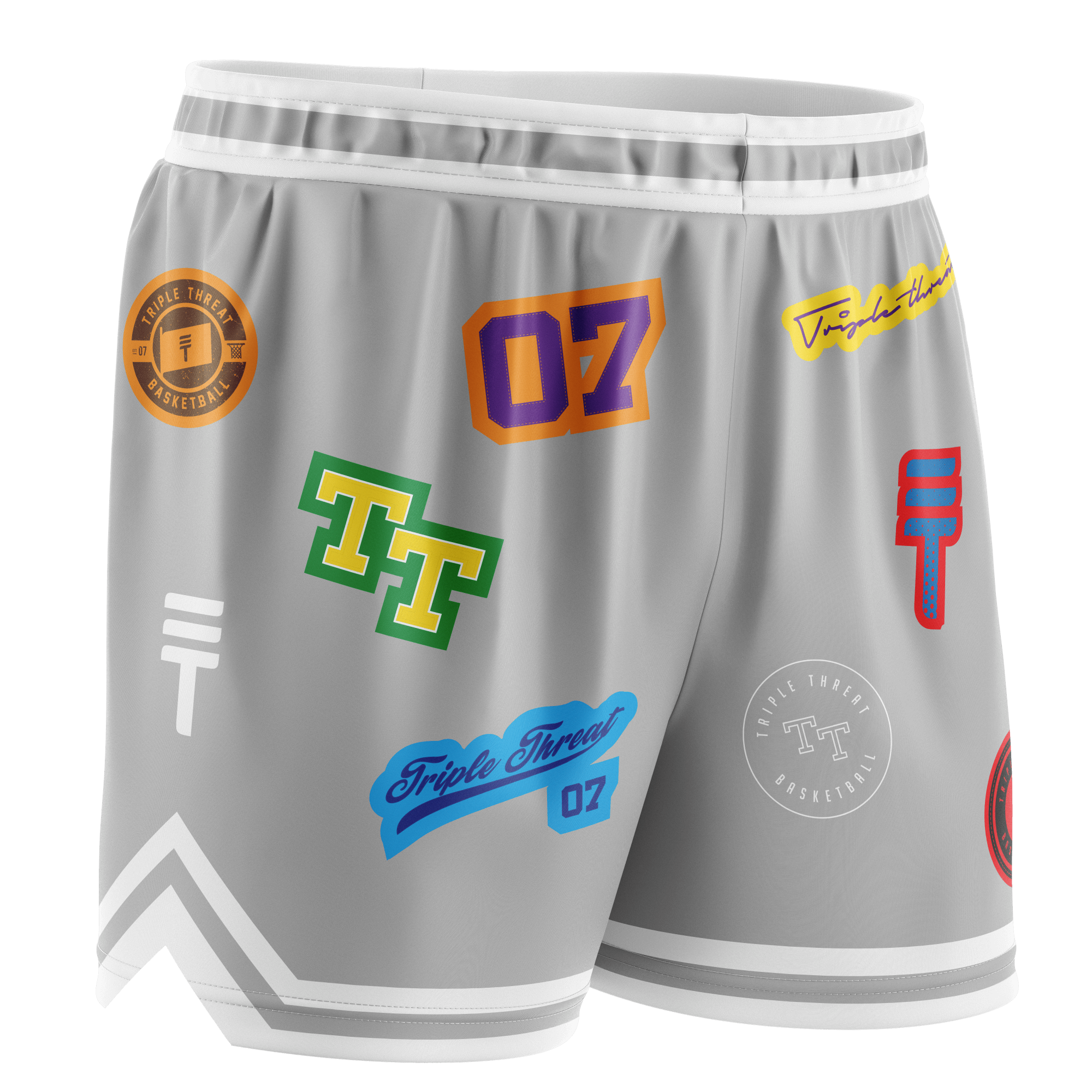 Grey basketball shorts featuring various colourful logos and designs, with an elastic waistband, white trim, and the Triple Threat logo.