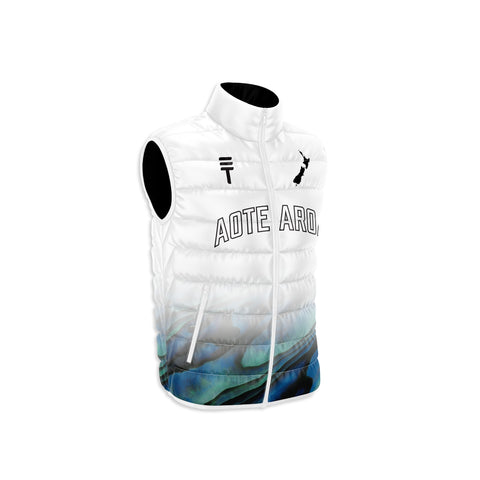 white puffer vest with the Triple Threat logo and NZ map outline in black, with the text " Aotearoa" across the center with a paua design at the bottom 