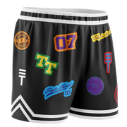 Kids black basketball shorts with colourful logos, white accents, elastic waistband, and the Triple Threat logo